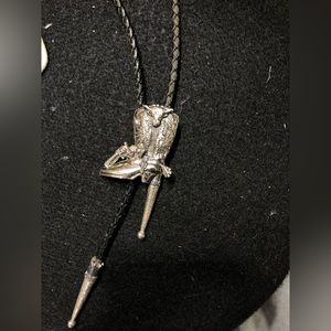 Cowboy boot bolo tie, leather cord and detailed charm.